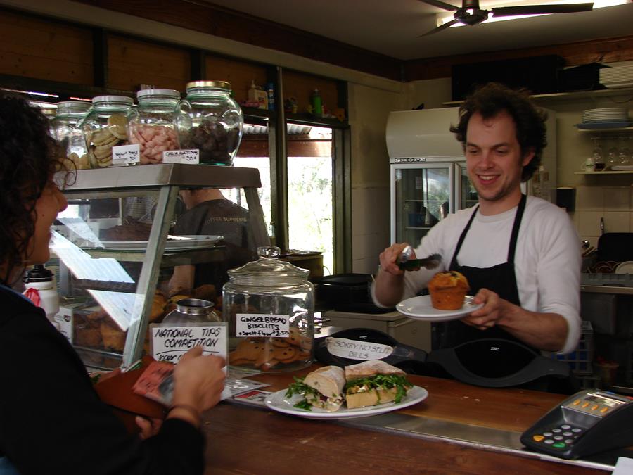 Nara serving a customer at the original CERES Cafe, East Brunswick