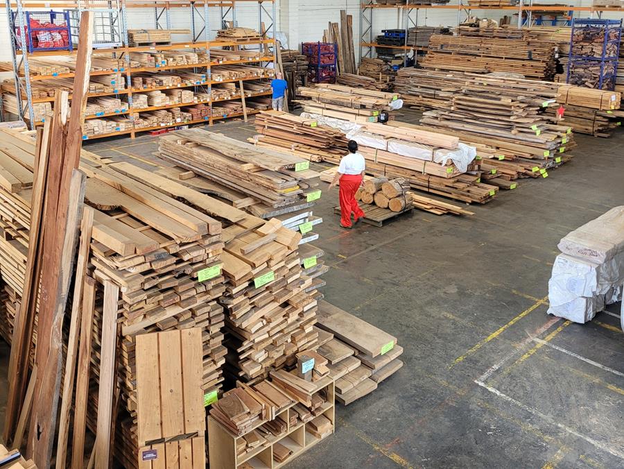 CERES Fair Wood warehouse, Preston - timber stacked in piles for sale.