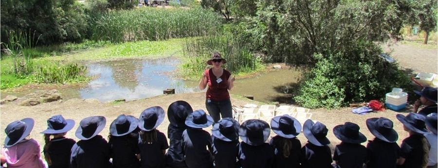 CERES pond with educator and students