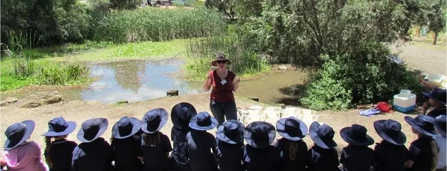 CERES pond with educator and students